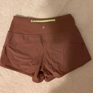 LULULEMON DUSTY ROSE SHORTS w/ neon green zipper